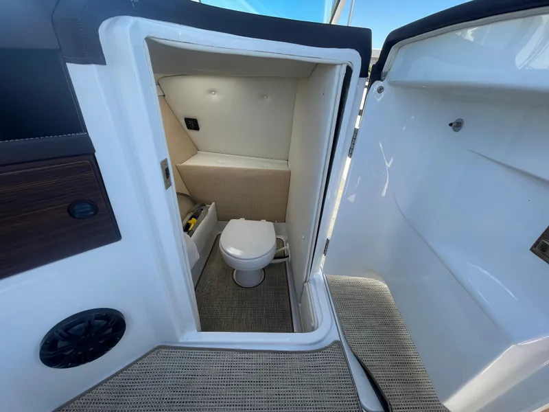 Slide: The Image of 2016 Cobalt R5 boat interior with compact bathroom and toilet. - 28