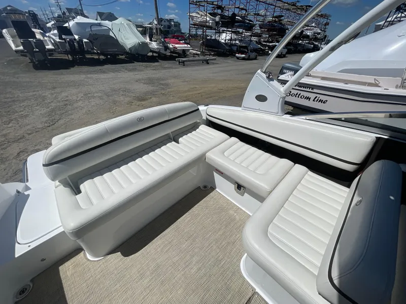 Slide: The Image of 2016 Cobalt R5 boat interior with white leather seating, docked at a marina. - 29