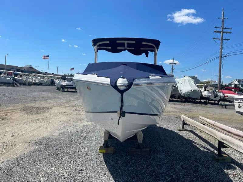 Slide: The Image of 2016 Cobalt R5 boat with cover in a marina under clear blue sky. - 3