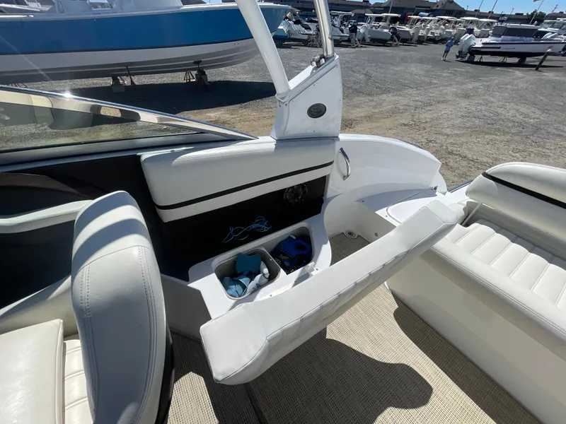 Slide: The Image of 2016 Cobalt R5 boat interior with white seating and storage compartment. - 32