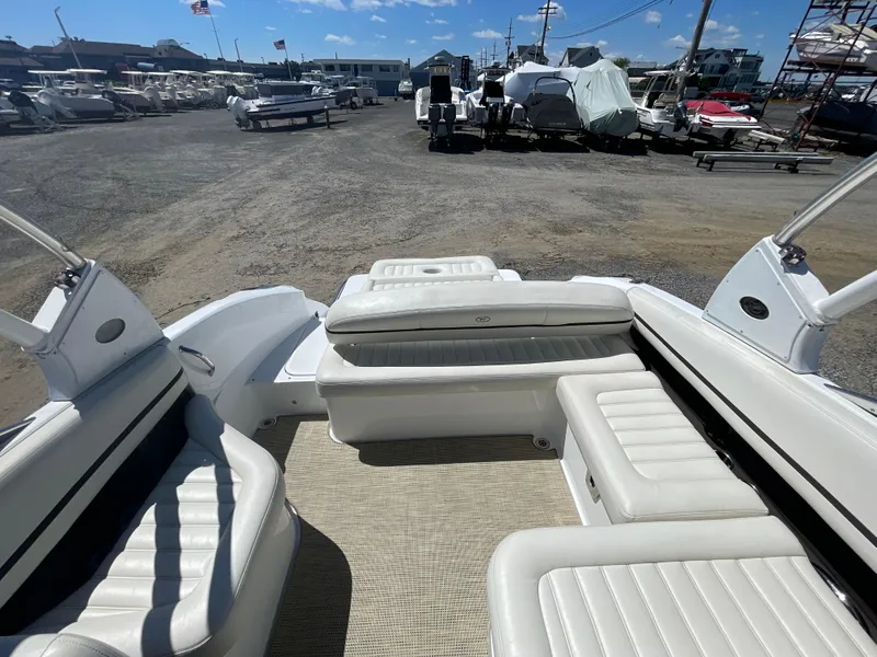 Slide: The Image of 2016 Cobalt R5 boat interior with white seating, parked in a marina. - 34