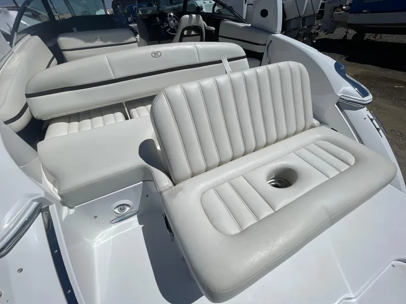 Slide: The Image of 2016 Cobalt R5 boat interior with white leather seating and cup holder. - 36