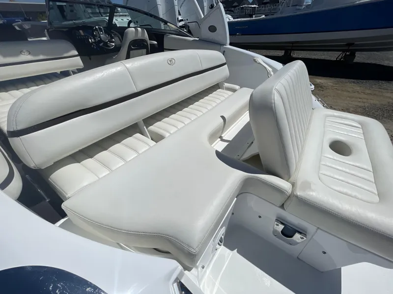 Slide: The Image of 2016 Cobalt R5 boat interior with white leather seating and cup holder. - 37