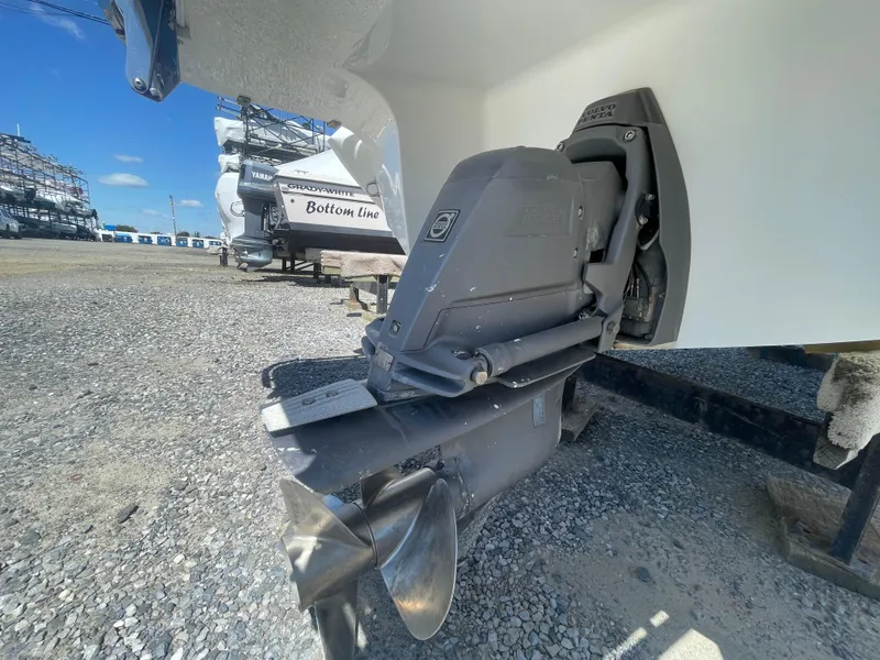 Slide: The Image of 2016 Cobalt R5 boat outdrive on gravel lot, showcasing propeller and engine details. - 42