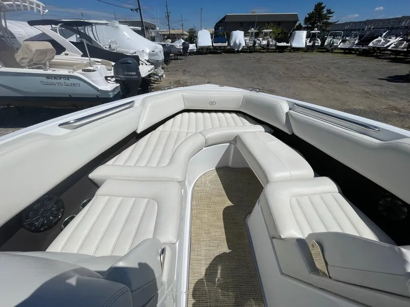 Slide: The Image of 2016 Cobalt R5 boat interior with white leather seating and outdoor storage area. - 9