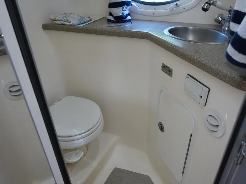 Slide: The Image of 2008 Rinker 330 Express Cruiser bathroom with toilet, sink, and countertop. - 11