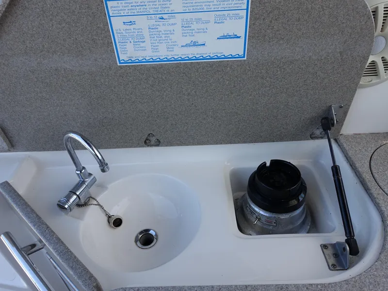 Slide: The Image of 2008 Rinker 330 Express Cruiser sink and faucet setup on deck. - 22
