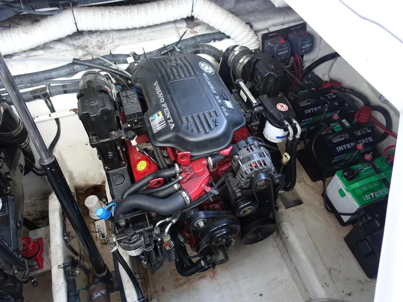 Slide: The Image of Engine compartment of a 2008 Rinker 330 Express Cruiser with visible components and batteries. - 27