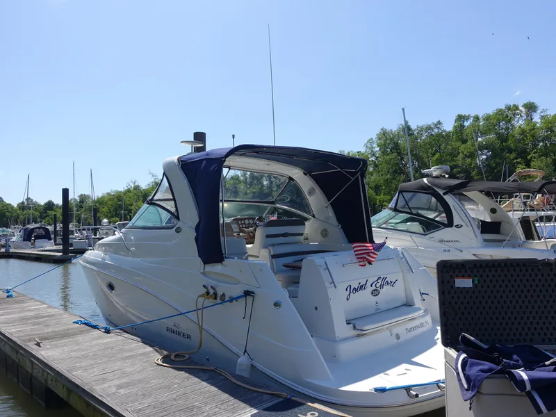 Slide: The Image of 2008 Rinker 330 Express Cruiser docked at marina, featuring sleek design and canopy. - 30