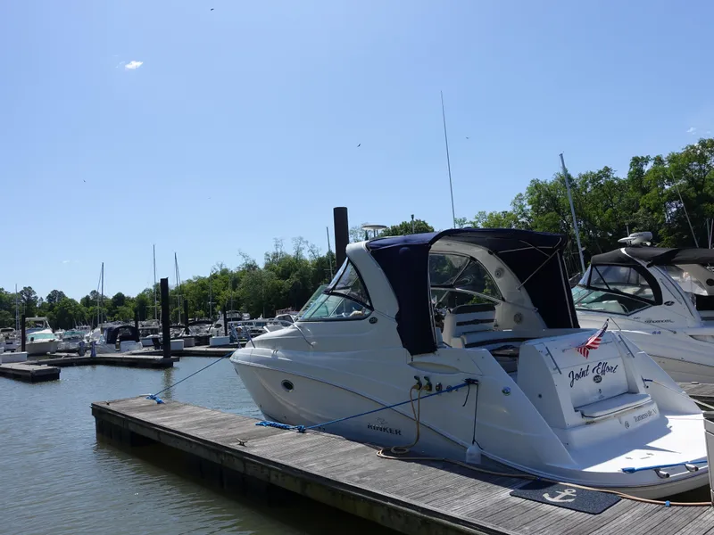 Slide: The Image of 2008 Rinker 330 Express Cruiser docked at a marina on a sunny day. - 31