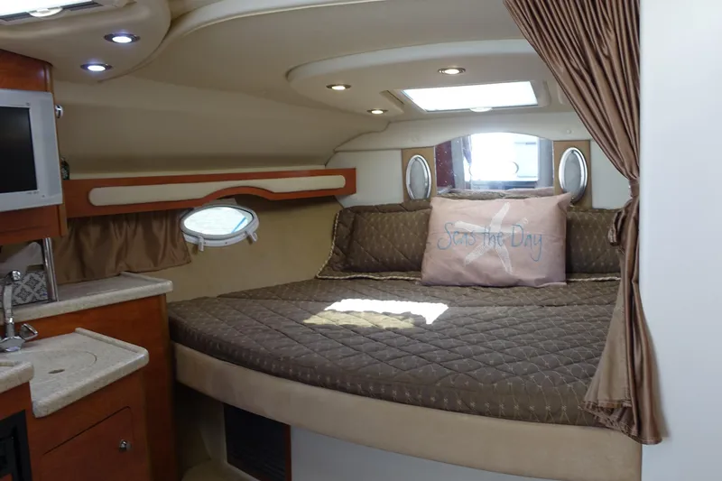 Slide: The Image of 2008 Rinker 330 Express Cruiser cabin with cozy bed and elegant interior design. - 6
