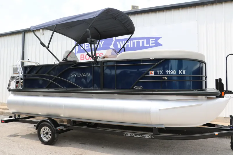 Slide: The Image of 2023 Sylvan Mirage Fish 820 Party Fish pontoon boat on trailer, blue canopy, side view. - 12
