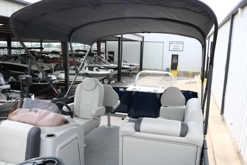 Slide: The Image of 2023 Sylvan Mirage Fish 820 Party Fish pontoon boat interior with canopy in showroom. - 16