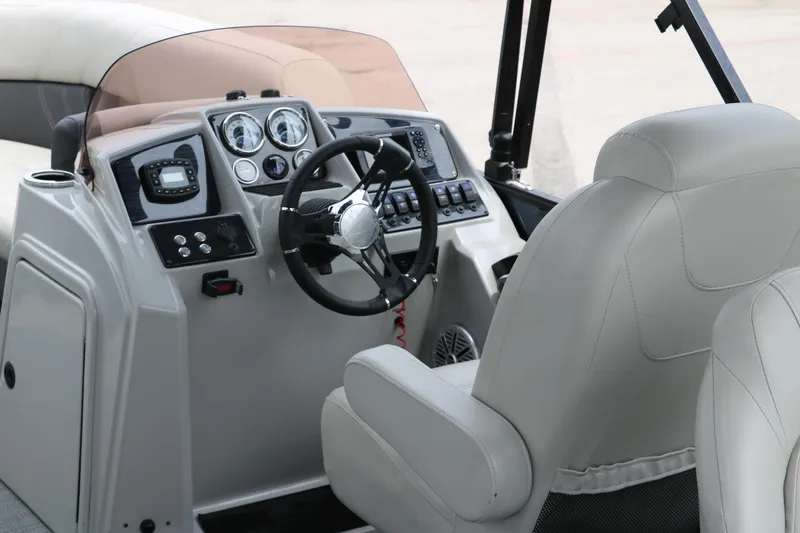 Slide: The Image of 2023 Sylvan Mirage Fish 820 Party Fish boat dashboard with steering wheel and controls. - 20