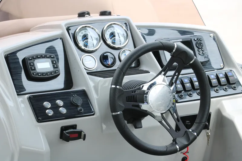 Slide: The Image of 2023 Sylvan Mirage Fish 820 Party Fish dashboard with steering wheel and control panel. - 21