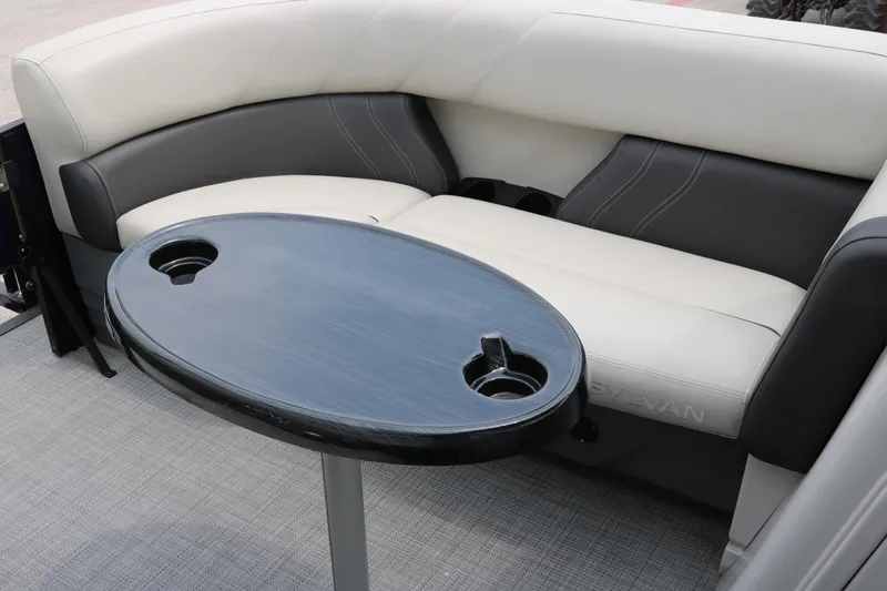 Slide: The Image of 2023 Sylvan Mirage Fish 820 Party Fish boat interior with cushioned seating and table. - 29