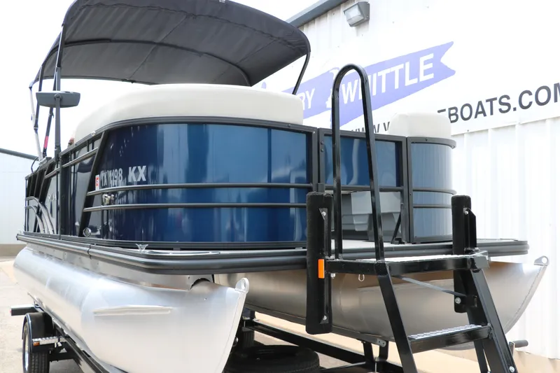 Slide: The Image of 2023 Sylvan Mirage Fish 820 Party Fish pontoon boat with blue exterior and canopy. - 9