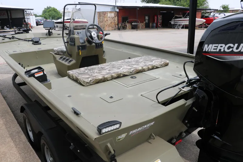 Slide: The Image of 2024 Tracker Grizzly 2072 MVX boat with Mercury engine, parked outdoors. - 10