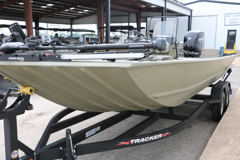 Slide: The Image of 2024 Tracker Grizzly 2072 MVX boat on trailer, featuring Minn Kota trolling motor. - 11