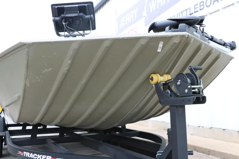 Slide: The Image of 2024 Tracker Grizzly 2072 MVX boat on trailer, featuring a sturdy hull design. - 12