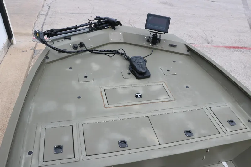 Slide: The Image of 2024 Tracker Grizzly 2072 MVX boat deck with control panel and mounted equipment. - 13