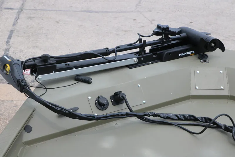 Slide: The Image of 2024 Tracker Grizzly 2072 MVX boat with Minn Kota trolling motor on deck. - 14