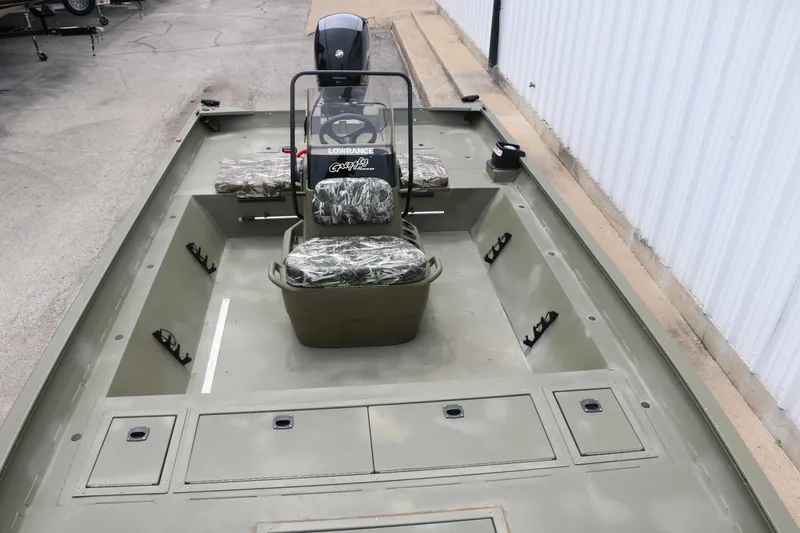 Slide: The Image of 2024 Tracker Grizzly 2072 MVX boat, spacious interior, camouflage seats, and steering console. - 18