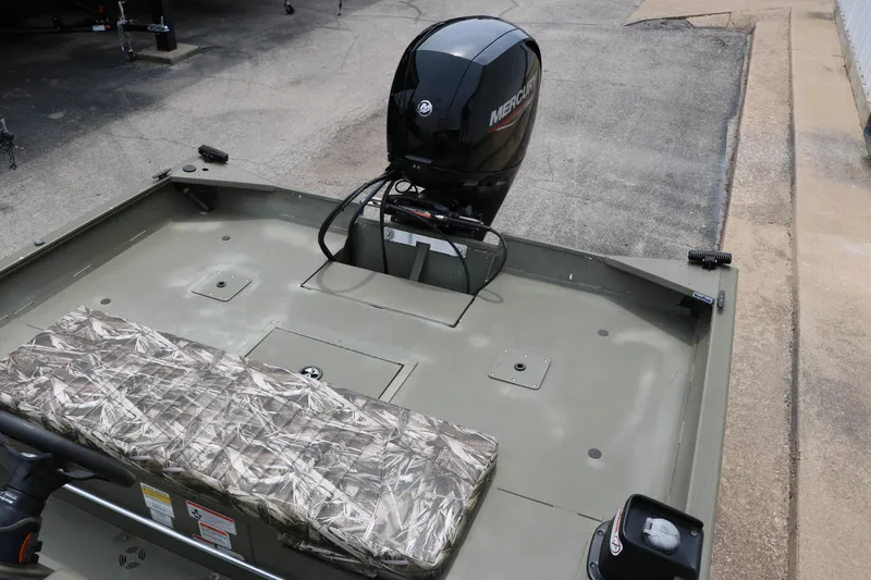 Slide: The Image of 2024 Tracker Grizzly 2072 MVX boat with Mercury outboard motor, camo seating. - 21