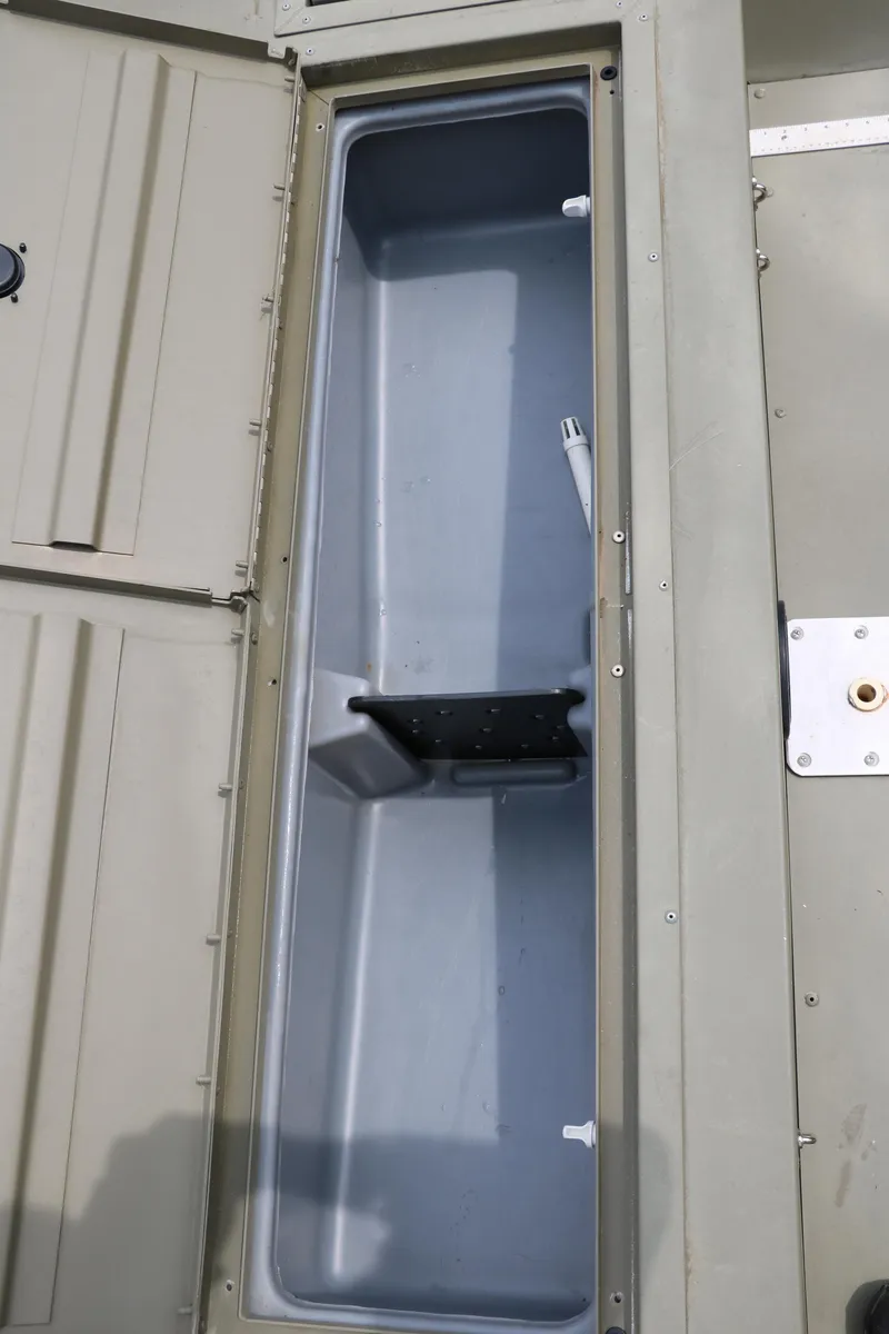 Slide: The Image of 2024 Tracker Grizzly 2072 MVX storage compartment, open and empty, showcasing interior space. - 22