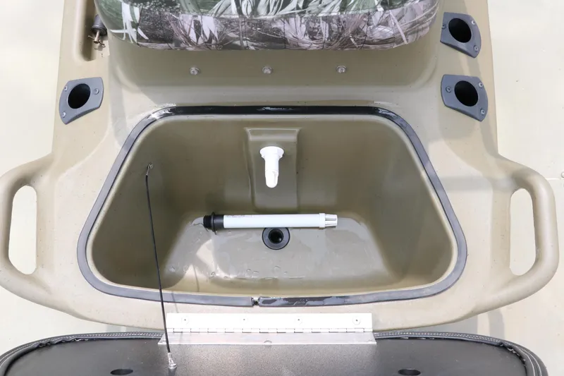 Slide: The Image of 2024 Tracker Grizzly 2072 MVX boat interior with storage compartment and rod holders. - 23