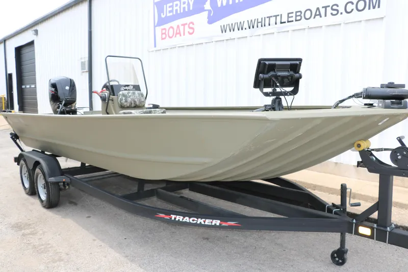 Slide: The Image of 2024 Tracker Grizzly 2072 MVX boat on trailer, parked outside dealership. - 3