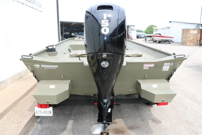 Slide: The Image of 2024 Tracker Grizzly 2072 MVX boat with powerful 150 HP outboard motor, rear view. - 8