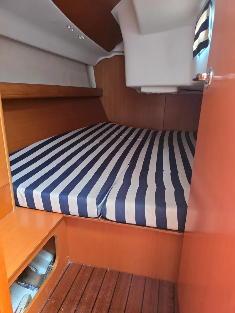 Slide: The Image of Beneteau First 40.7 cabin interior with striped bedding, 2000 model. - 12