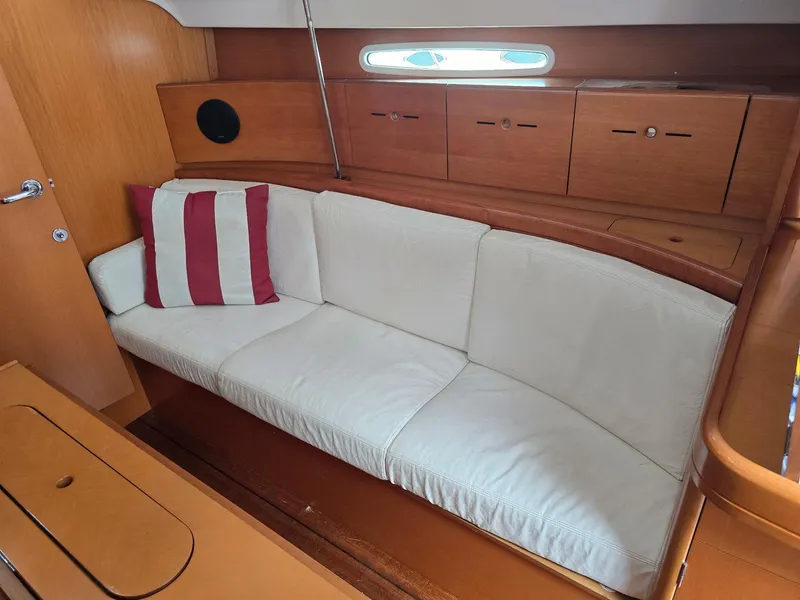 Slide: The Image of Interior of 2000 Beneteau First 40.7 yacht with white sofa and striped pillow. - 14