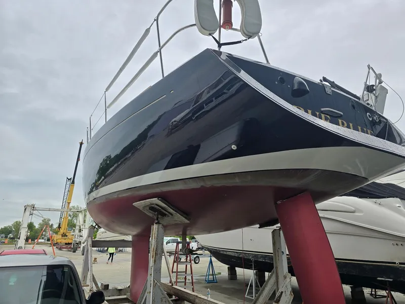 Slide: The Image of Beneteau First 40.7 sailboat from 2000 on dry dock, showcasing hull and keel. - 2