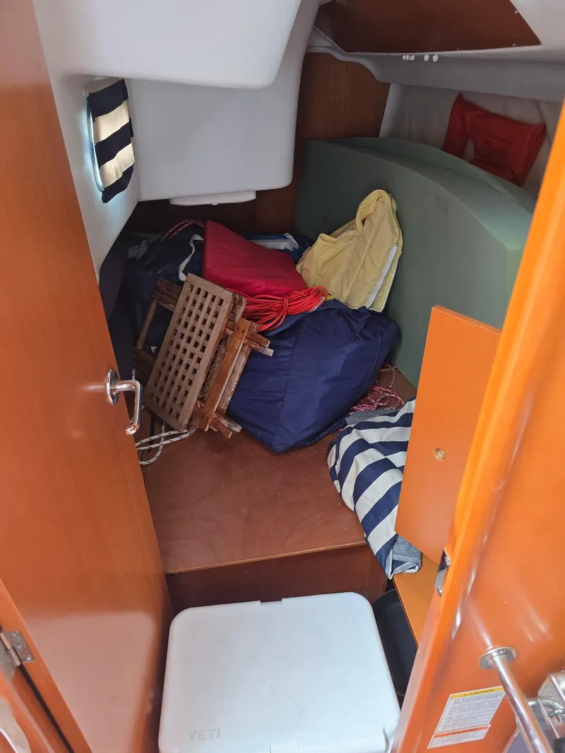 Slide: The Image of Cabin interior of 2000 Beneteau First 40.7 sailboat with stored items and wooden furniture. - 20