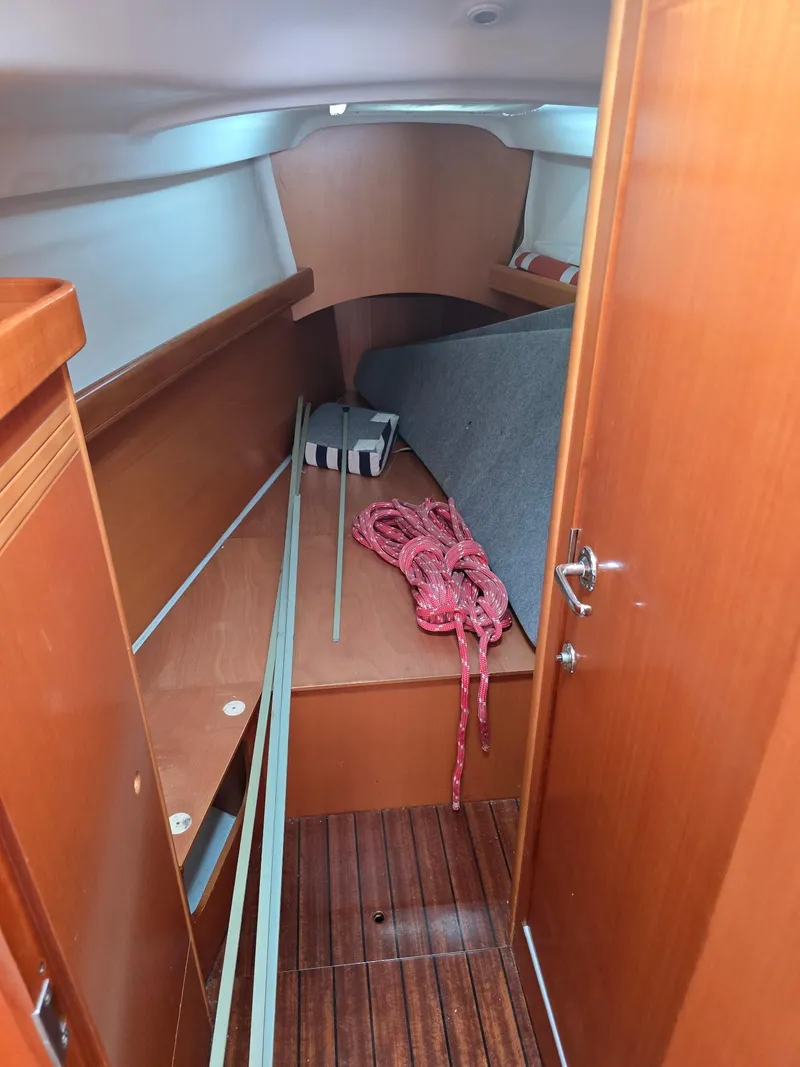 Slide: The Image of Interior cabin of 2000 Beneteau First 40.7 sailboat with wooden finish and red rope. - 21