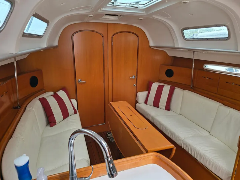Slide: The Image of Interior of 2000 Beneteau First 40.7 sailboat with cozy seating and wooden finishes. - 25