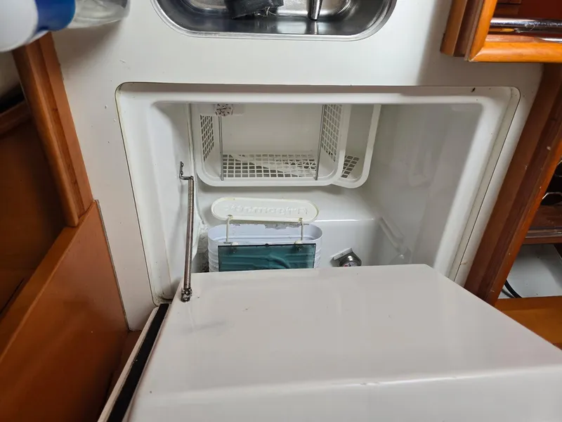 Slide: The Image of Beneteau First 40.7 yacht interior fridge, open with storage compartments, 2000 model. - 27