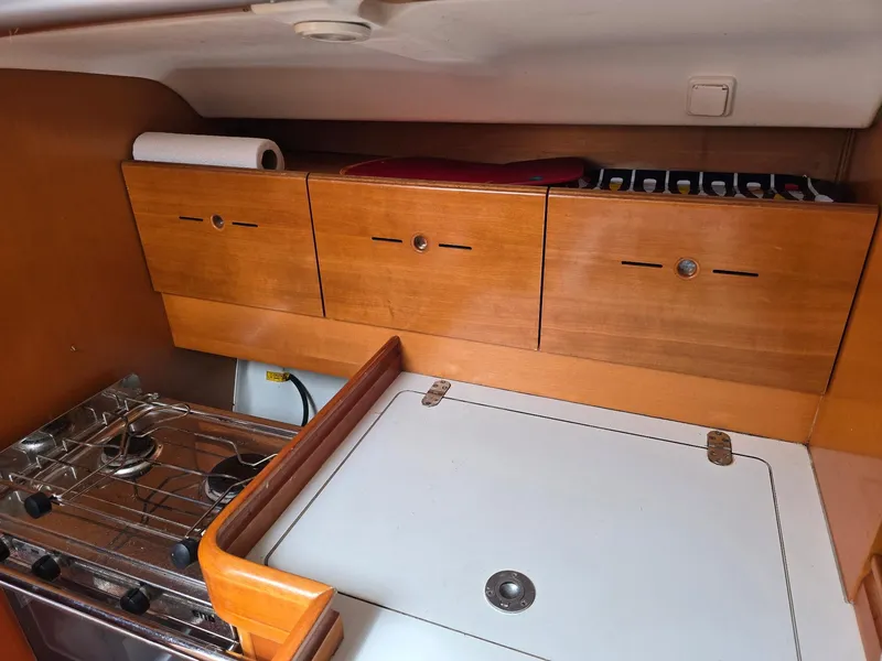 Slide: The Image of Beneteau First 40.7 yacht kitchen with wooden cabinets and stove, 2000 model. - 28
