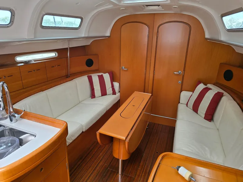 Slide: The Image of Interior of 2000 Beneteau First 40.7 yacht with wood finish and white seating. - 29
