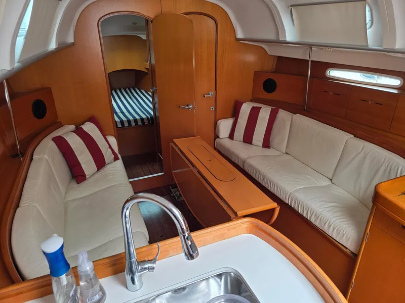 Slide: The Image of Interior of 2000 Beneteau First 40.7 yacht with cozy seating and wooden finishes. - 30