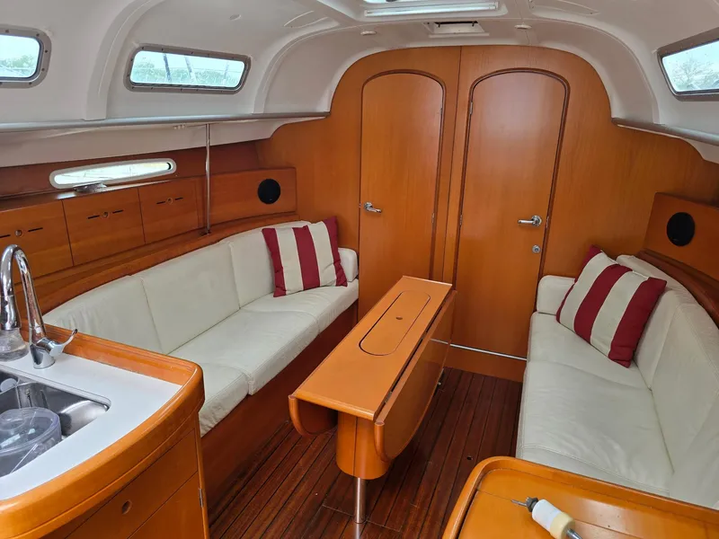 Slide: The Image of Interior of 2000 Beneteau First 40.7 yacht with wood finish and white seating. - 31