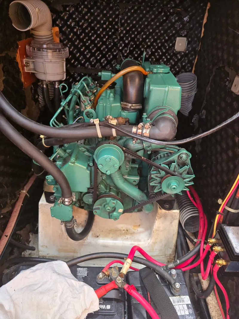 Slide: The Image of Engine compartment of a 2000 Beneteau First 40.7 sailboat, featuring a green marine engine. - 34