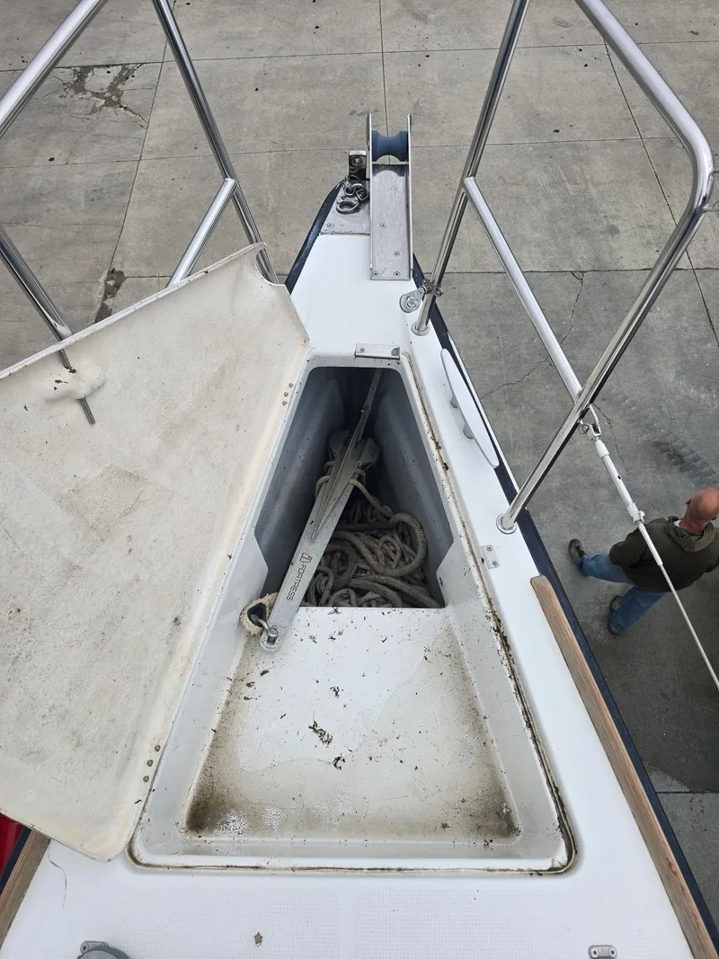 Slide: The Image of Open anchor locker on a 2000 Beneteau First 40.7 sailboat, showing anchor and rope. - 7