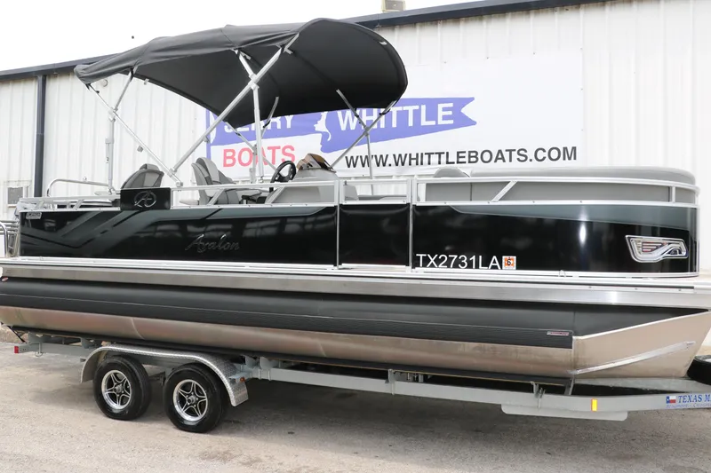 Slide: The Image of 2023 Avalon Venture 2385 RF pontoon boat on trailer, black exterior, at Whittle Boats dealership. - 13
