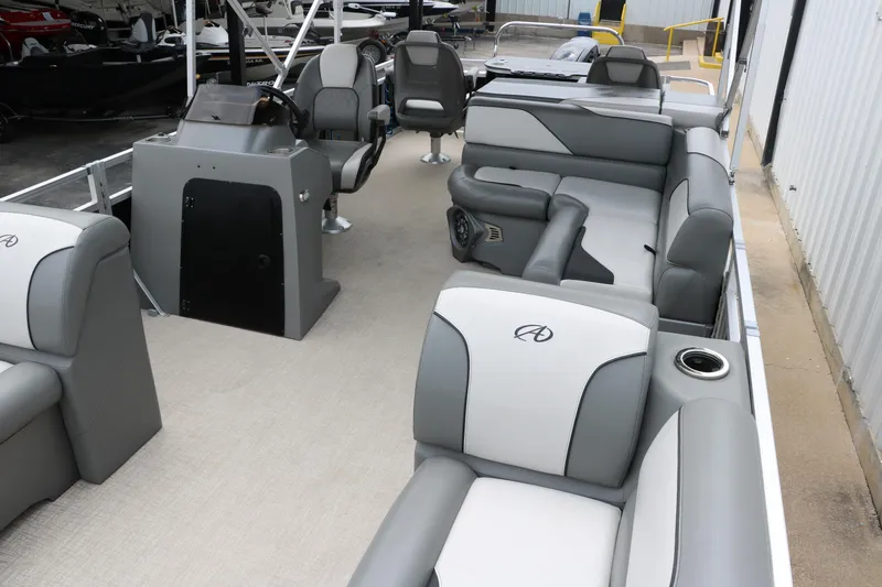 Slide: The Image of 2023 Avalon Venture 2385 RF pontoon boat with spacious seating and canopy in a showroom. - 16