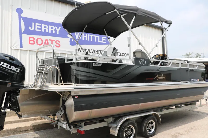 Slide: The Image of 2023 Avalon Venture 2385 RF pontoon boat on trailer at dealership. - 2