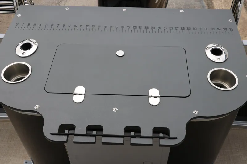 Slide: The Image of 2023 Avalon Venture 2385 RF boat console with cup holders and measurement markings. - 24