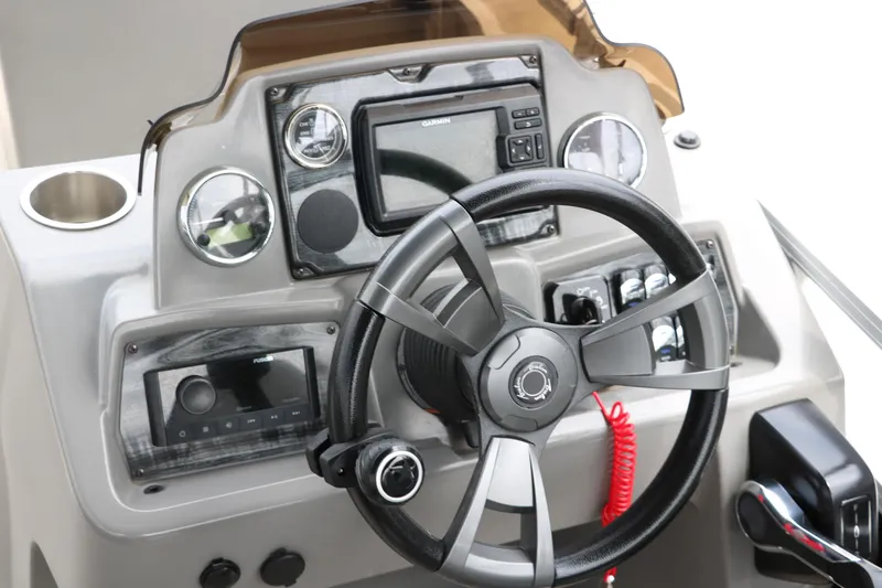 Slide: The Image of 2023 Avalon Venture 2385 RF boat interior with gray seating and speaker system. - 26